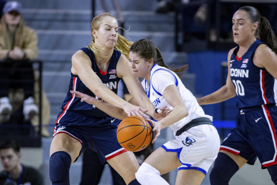 UConn's Dorka Juhasz, left, reaches for the ball against Creighton's Lauren Jensen during the first half of an NCAA college basketball game Wednesday, Dec. 28, 2022, in Omaha, Neb. (AP Photo/John Peterson)
