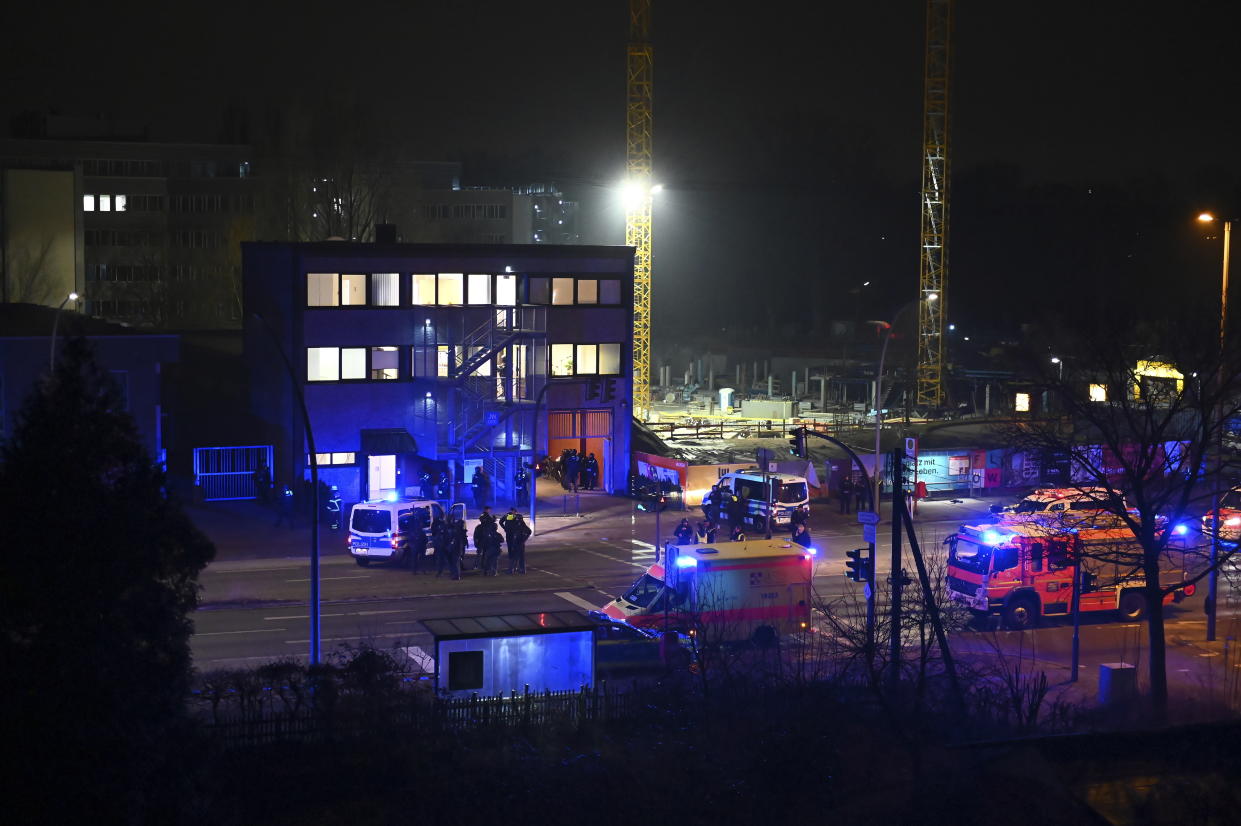 Armed police officers and emergency services near the scene of a shooting in Hamburg, Germany on Thursday March 9, 2023 after one or more people opened fire in a church. The Hamburg city government says the shooting took place in the Gross Borstel district on Thursday evening. (Jonas Walzberg/dpa via AP)