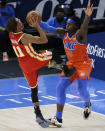 Atlanta Hawks guard Trae Young (11) shoots against Oklahoma City Thunder forward Luguentz Dort (5) during the first half of an NBA basketball game Friday, Feb. 26, 2021, in Oklahoma City. (AP Photo/Garett Fisbeck)