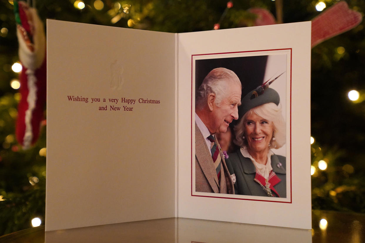 The 2022 Christmas card of King Charles III and the Queen Consort in front of a Christmas tree in Clarence House, London. (Sam Hussein / PA)