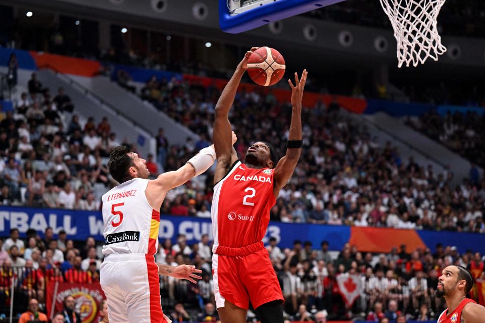 Canada’s Shai Gilgeous-Alexander (R) and Rudy Fernandez (L) vie for a ball during the FIBA Basketball World Cup match between Spain and Canada at Indonesia Arena in Jakarta on September 3, 2023. (Photo by ADEK BERRY / AFP) (Photo by ADEK BERRY/AFP via Getty Images)