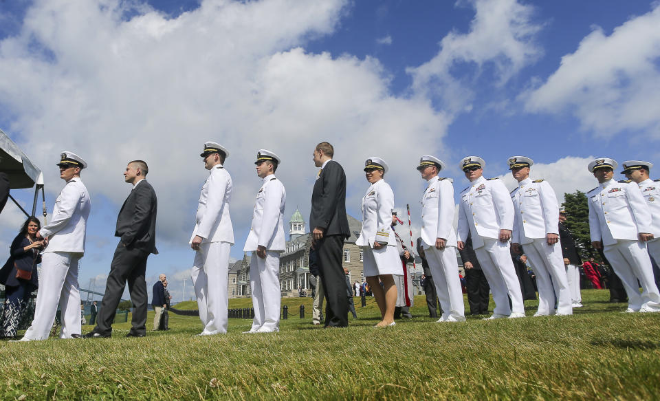 Members of the graduating class of 2019 lineup for the ceremony during the U.S. Naval War College's commencement ceremony, Friday, June 14, 2019, in Newport, R.I. (AP Photo/Stew Milne)
