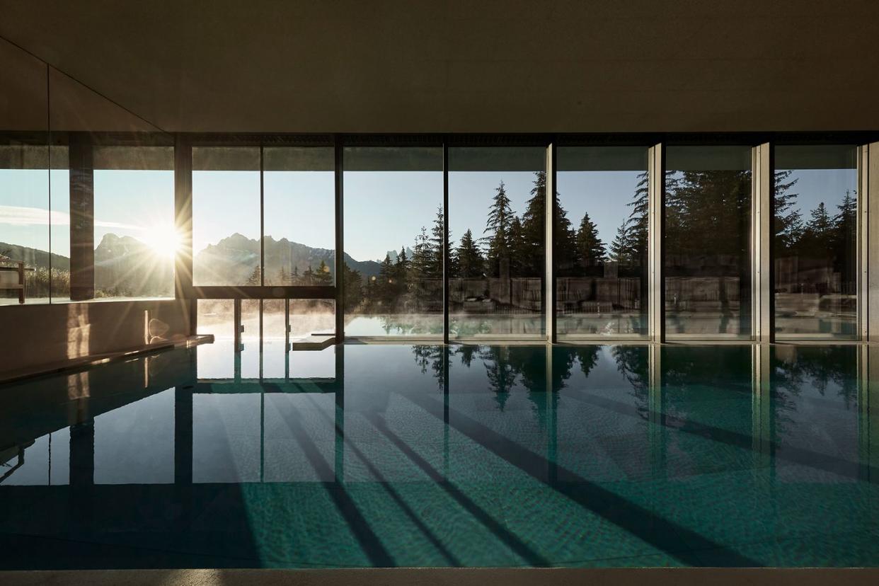 a pool with a view of the sun and trees