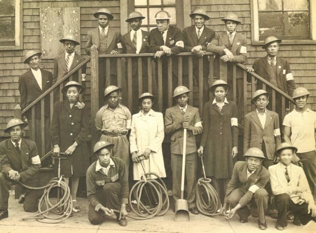 This photo of an all-Black fire brigade is on display at The Army Museum, and staff are asking people on social media to help identify the members of the group. (The Army Museum - image credit)