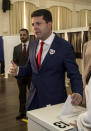 Chief Minister of Gibraltar Fabian Picardo places his vote during general elections in Gibraltar, Thursday Oct. 17, 2019. An election for Gibraltar's 17-seat parliament is taking place Thursday under a cloud of uncertainty about what Brexit will bring for this British territory on Spain's southern tip. (AP Photo/Javier Fergo)