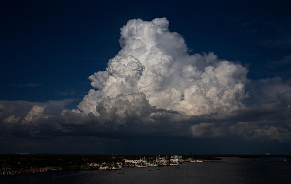 Clouds billow over the shrimp docks on San Carlos Island on Fort Myers Beach on Thursday, Sept. 7, 2023. Nearly a year after Hurricane Ian tossed most of the shrimp boats ashore, Erickson & Jensen Seafood Packer was surviving but struggling. High fuel prices and low shrimp prices are not helping as they rebuild.