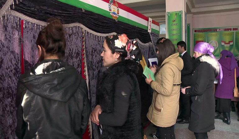 Local residents queue to enter a voting booth during a vote in a polling station in Dushanbe on March 1, 2015