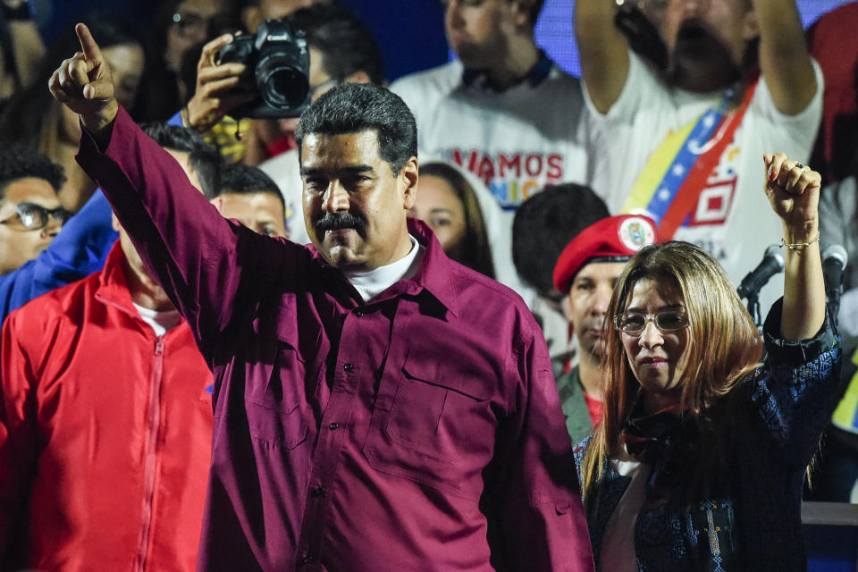 El presiente de Venezuela, Nicolás Maduro, saluda a la multitud, junto a su esposa Cilia Flores, tras conocer los resultados de las elecciones presidenciales, el 20 de mayo de 2018 en Caracas.