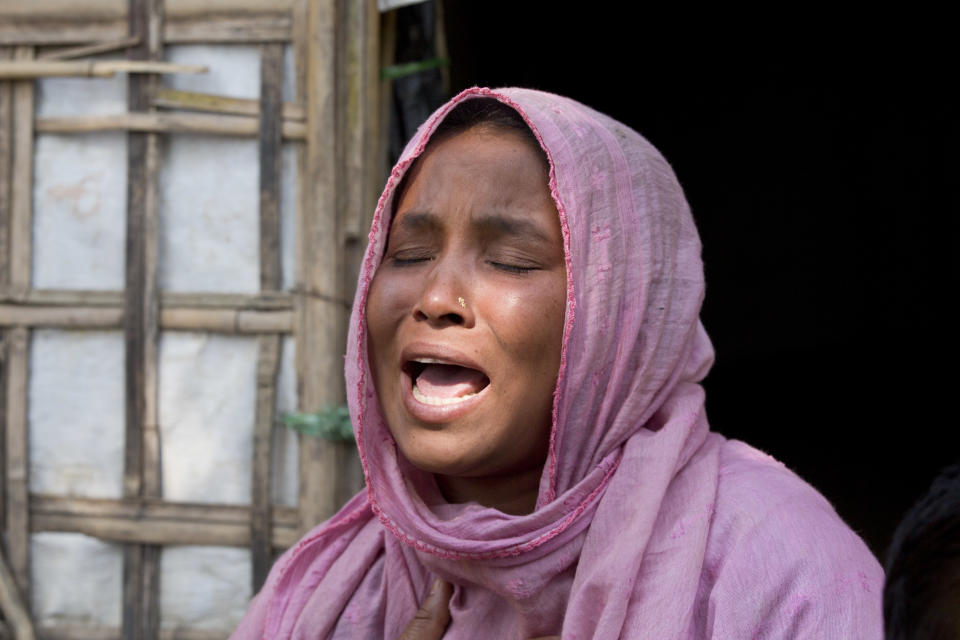 Rohingya refugee woman Johara, 30, a mother of five children, breaks down while talking to the Associated Press in Unchiprang refugee camp near Cox's Bazar, in Bangladesh, Friday, Nov. 16, 2018. Normal life returned to a Rohingya Muslim refugee camp in Bangladesh on Friday a day after government officials postponed plans to begin repatriating residents to Myanmar when no one volunteered to go. Johara, who goes by one name, said her husband left to find his parents at another camp after the family found out they were on the government's repatriation list. Johara's husband left with their 6-year-old daughter, who was traumatized after witnessing Myanmar soldiers ransack her home village. (AP Photo/Dar Yasin)