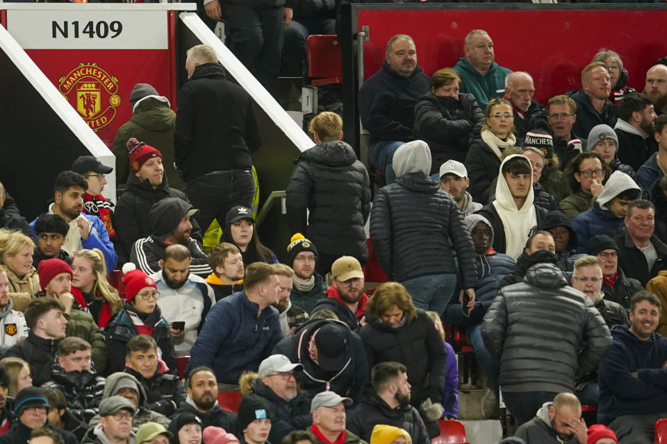 Fans leave after Newcastle's Joe Willock scoring his side's third goal during the EFL Cup fourth round soccer match between Manchester United and Newcastle at Old Trafford stadium in Manchester, England, Wednesday, Nov. 1, 2023. (AP Photo/Dave Thompson)