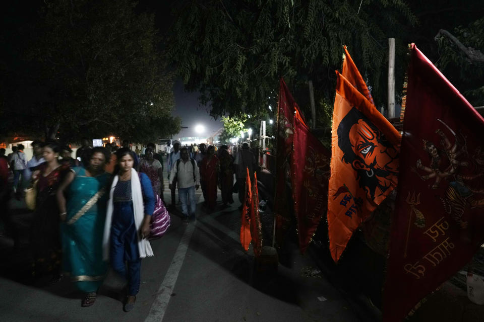 People sell flags with images of Hindu monkey god Hanuman on the side of a road as devotees arrive to for Ramvami festival, celebrated as the birthday of Hindu god Ram, in Ayodhya, India, March 29, 2023. Ayodhya is also considered as the birth place of Lord Ram. (AP Photo/Manish Swarup)