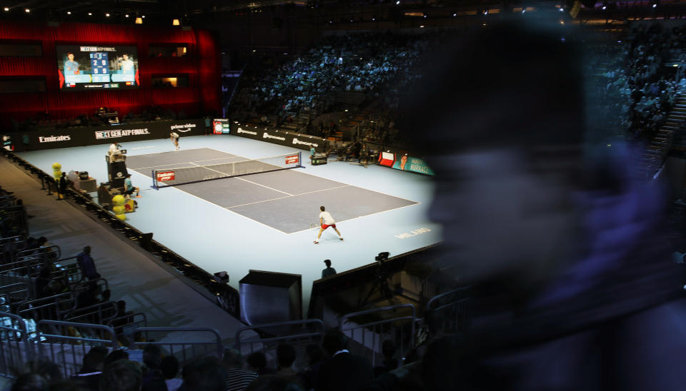 A boy walks along the stands as Jaume Munar of Spain plays Hubert Hurkacz of Poland , during the ATP Next Gen tennis tournament, at the Rho fair, near Milan, Italy, Wednesday, Nov. 7, 2018. The even is featuring many of the innovations that debuted last year such as free movement for spectators who can get up and walk around during matches, except behind the baseline. (AP Photo/Luca Bruno)