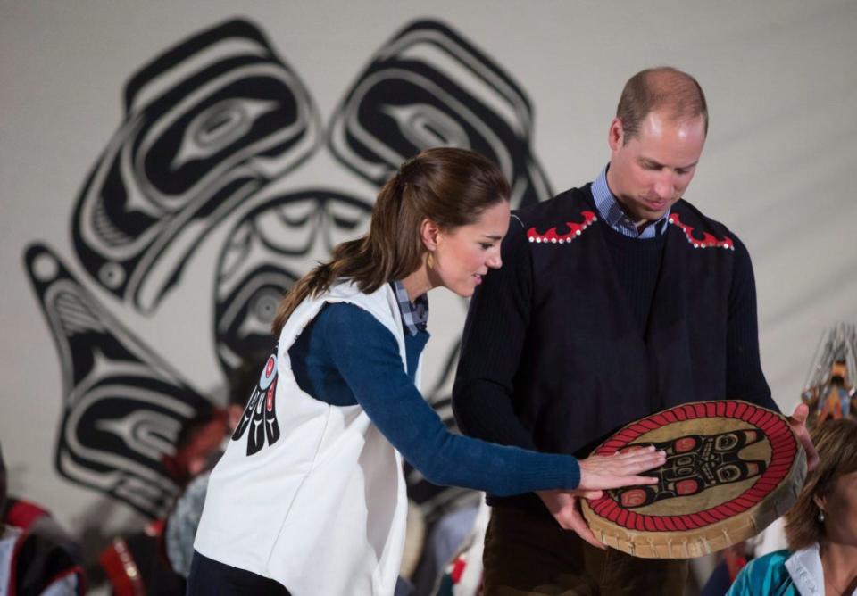 Wearing First Nations vests they were given, Prince William, the Duke of Cambridge, and Kate, the Duchess of Cambridge, hold a traditional drum they were presented during a welcoming ceremony at the Heiltsuk First Nation in the remote community of Bella Bella, B.C., on Monday September 26, 2016. THE CANADIAN PRESS/Darryl Dyck