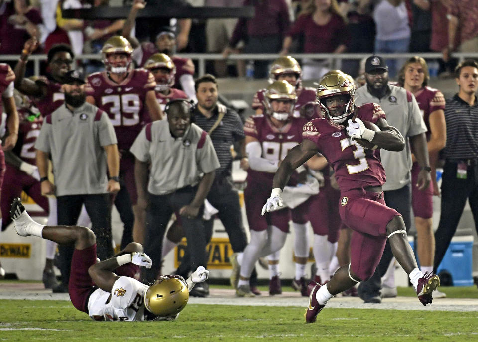 Sept. 24, 2022; Tallahassee, Florida; Florida State Seminoles running back Trey Benson (3) returns the opening kickoff for a touchdown against Boston College Eagles cornerback Josh DeBerry (21) at Doak S. Campbell Stadium. Melina Myers-USA TODAY Sports