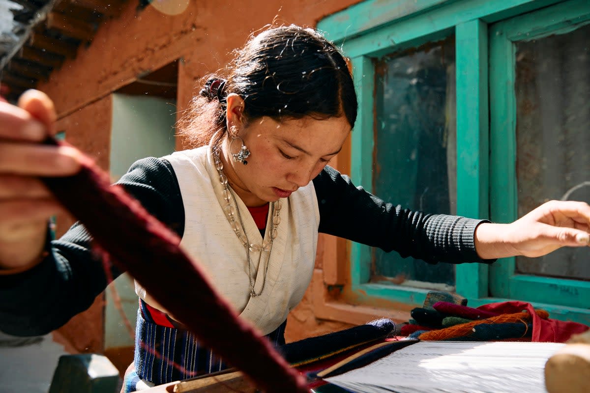 Chiring Dhaka Gurung, 22, says: ‘Symrik Cashmere is helping women in these remote regions to be able to support themselves through training in faster weaving techniques which increases output’  (Paddy Dowling)