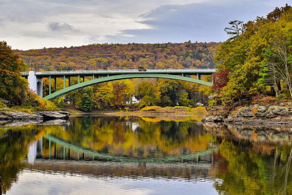 This picture, taken from where the Delaware River is deepest and often creates a whirlpool at Narrowsburg, New York, shows in the background the Darbytown-Narrowsburg bridge and the narrowest part of the main stem of the river. The Pennsylvania side is to the left in this view looking north, upstream. The photo was taken in October 2020.