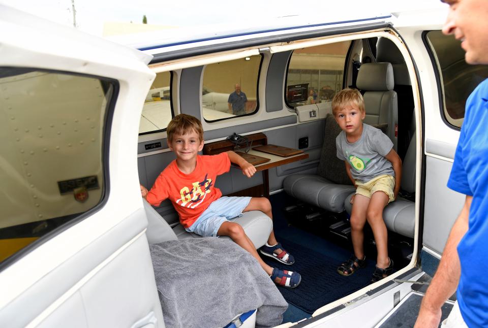 Lias Koster, 5, and his brother Joshua Koster, 3, check out a  Beechcraft Bonanza with dad, Moritz Koster.