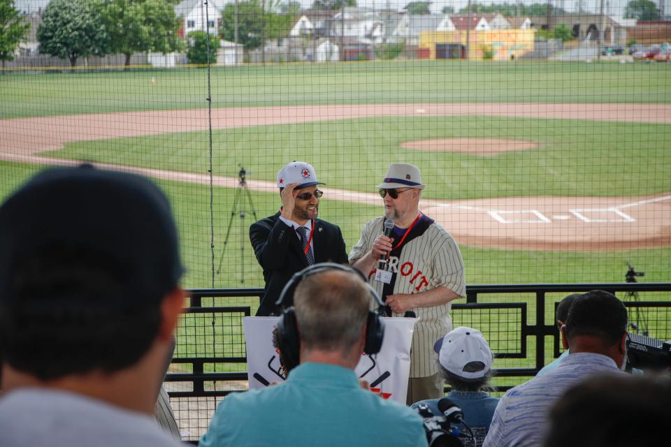 Gary Gillette, co-founder and chair of the board of directors of the Friends of Historic Hamtramck Stadium, gives Hamtramck Mayor Amer Ghalib a Historic Hamtramck Stadium cap at the Hamtramck Stadium in Hamtramck on June 20, 2022.