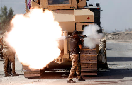 FILE PHOTO - An Iraqi special forces soldier fires an RPG during clashes with Islamic States fighters in Bartella, east of Mosul, Iraq October 20, 2016. REUTERS/Goran Tomasevic/File Photo