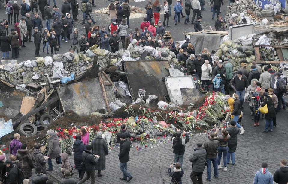 Flowers cover one of the barricades heading to Kiev's Independence Square, the epicenter of the country's recent unrest on a mourning day, Ukraine, Sunday, Feb. 23, 2014. Official reports say 82 people were killed in severe clashes between opposition activists and riot police. A top Ukrainian opposition figure assumed presidential powers Sunday, plunging Ukraine into new uncertainty after a deadly political standoff and boosting long-jailed Yulia Tymoshenko's chances at a return to power. (AP Photo/Efrem Lukatsky)