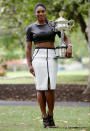 <p>Serena Williams poses with her Australian Open trophy in February wearing a leather crop top and white pencil skirt.</p>