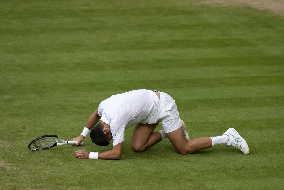 Serbia's Novak Djokovic after slipping when playing a return to Spain's Carlos Alcaraz in the final of the men's singles on day fourteen of the Wimbledon tennis championships in London, Sunday, July 16, 2023. (AP Photo/Alastair Grant)