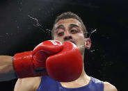 <p>Mohamed Flissi of Algeria competes in a men’s fly (52kg) Round of 16 bout during the Rio Olympics on August 15, 2016. (REUTERS/Yves Herman) </p>