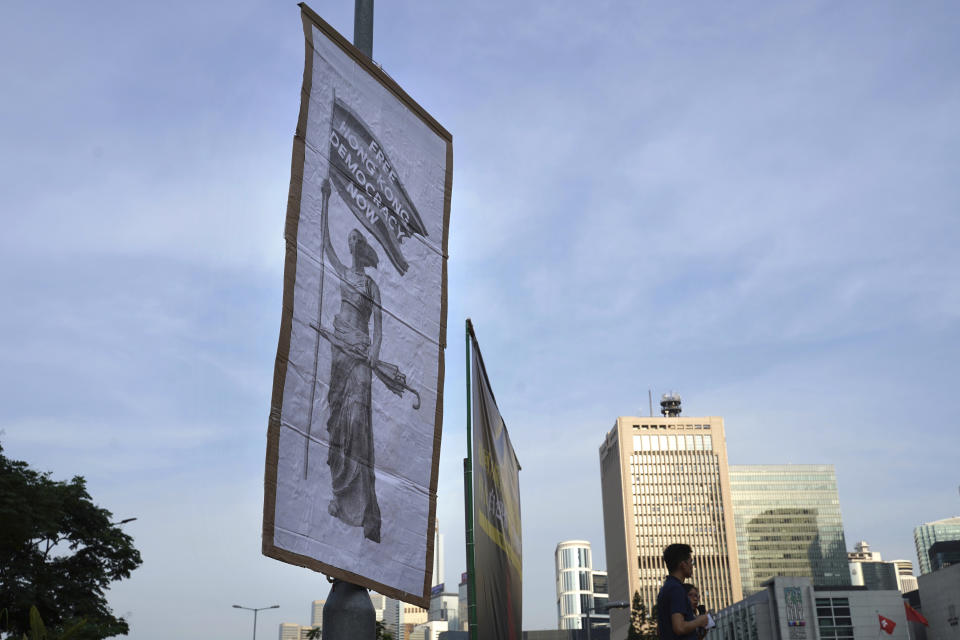 A sign reading: "Free Hong Kong, Democracy Now" hangs from a pole during a protest opposing the recent firings of Cathay Pacific employees in Hong Kong, Wednesday, Aug. 28, 2019. Trade union members in Hong Kong rallied against the city's flagship Cathay Pacific airline for firing employees apparently because of links to this summer's ongoing pro-democracy protests. (AP Photo/Vincent Yu)