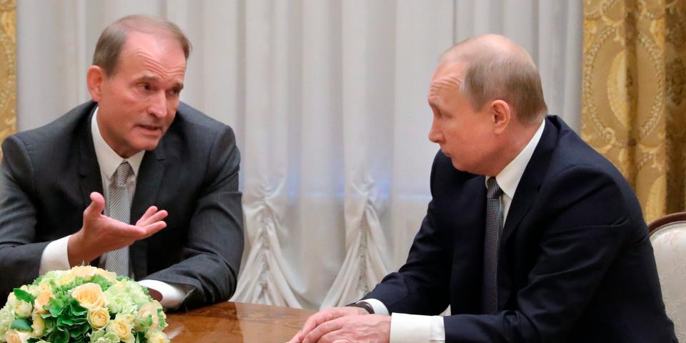 Viktor Medvedchuk sits across from Vladimir Putin.