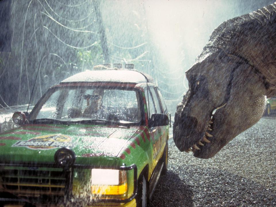 A Tyrannosaurus Rex menaces the theme park's first customers in a scene from the film 'Jurassic Park', 1993