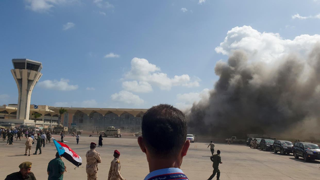Smoke billows at the Aden Airport on December 30, 2020, after explosions rocked the airport shortly after the arrival of a plane carrying members of a new unity government.  / Credit: SALEH AL-OBEIDI/AFP/Getty