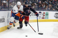 New York Islanders' Noah Dobson, left, and Columbus Blue Jackets' Oliver Bjorkstrand chase the puck during the second period of an NHL hockey game Thursday, Oct. 21, 2021, in Columbus, Ohio. (AP Photo/Jay LaPrete)