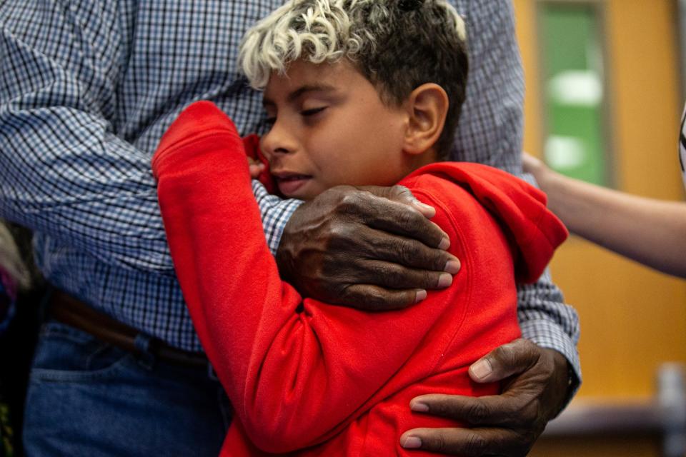 Third grade student Maverick Dennis, 8, hugs his grandfather Michael Dennis, a retired U.S. Air Force and Army veteran, at Kolda Elementary School's 10th anniversary and Veterans Day celebration on Nov. 7, 2022, in Corpus Christi, Texas.