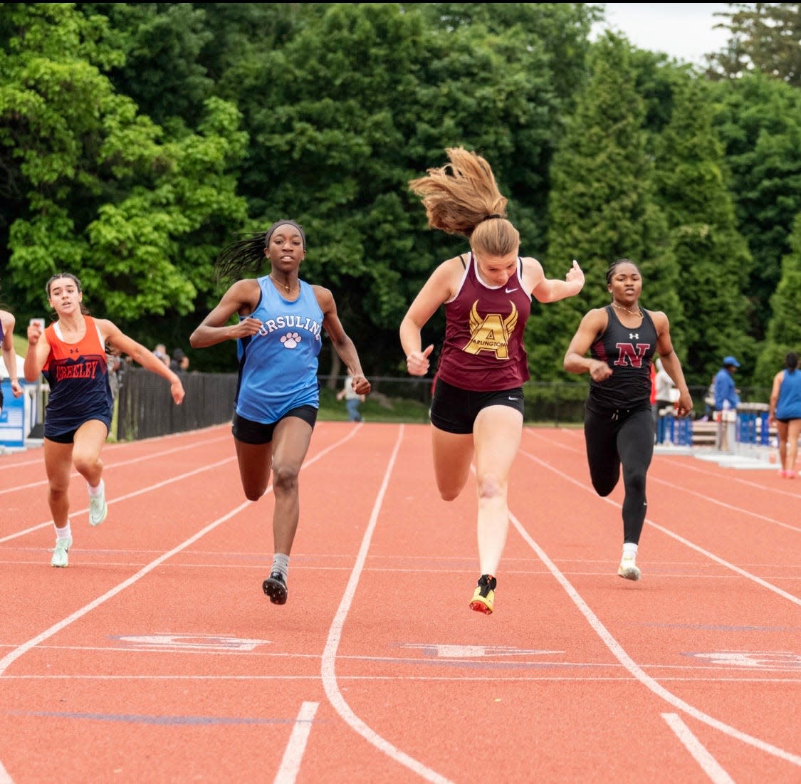 Arlington's Riley Pettigrew (center-right) edges Ursuline's Sarai Sealy at the finish of the girls D1 200 during the Section 1 state track and field qualifier June 3, 2023 at Suffern Middle School. Both runners qualified to compete in the event.