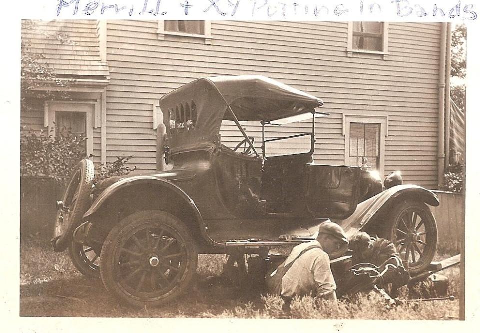 Merrill Leavens, the boy on the right, works on a car in Dorchester with his father, also named Merrill. His neighbor Pat Carson took many family photographs.