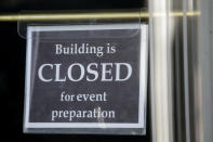 A "building is closed" sign is shown at an entrance of The Church of Jesus Christ of Latter-day Saints' Conference Center during the 190th Annual General Conference Saturday, April 4, 2020, in Salt Lake City. The twice-annual conference kicked off Saturday without anyone attending in person and top leaders sitting some 6 feet apart inside an empty room viewed via live-stream as the faith takes precautions to avoid the spread of the coronavirus. It is the first conference without a crowd since World War II, when wartime travel restrictions were in place. (AP Photo/Rick Bowmer)