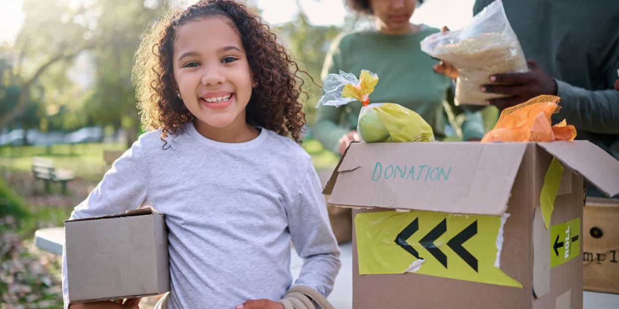 how to foster empathy through charity- little girl helping with donations