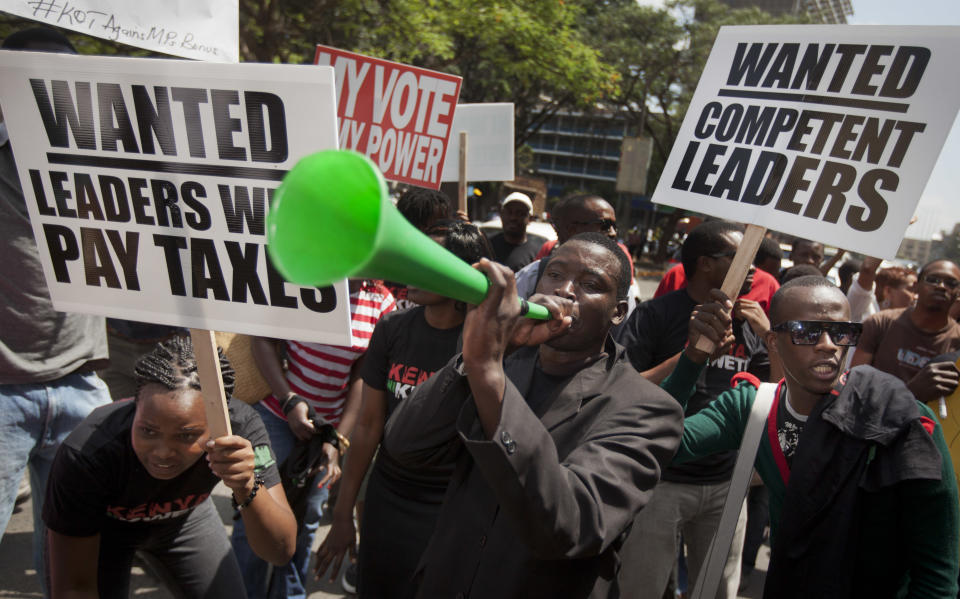 Kenyans demonstrate against their Members of Parliament who last week quietly awarded themselves a $110,000 bonus for five years of service in parliament, in downtown Nairobi, Kenya Tuesday, Oct. 9, 2012. Kenya's 222 legislators currently make about $120,000 a year, one of the highest pay packages in the world when compared to what the lawmakers' constituents make - around $5 a day for the average Kenyan. (AP Photo/Ben Curtis)