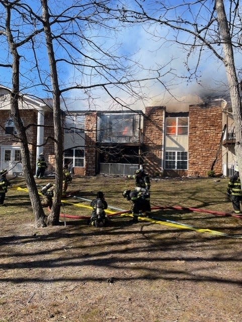 Firefighters attacked flames that engulfed a 16-unit apartment building in Manchester on Sunday afternoon.