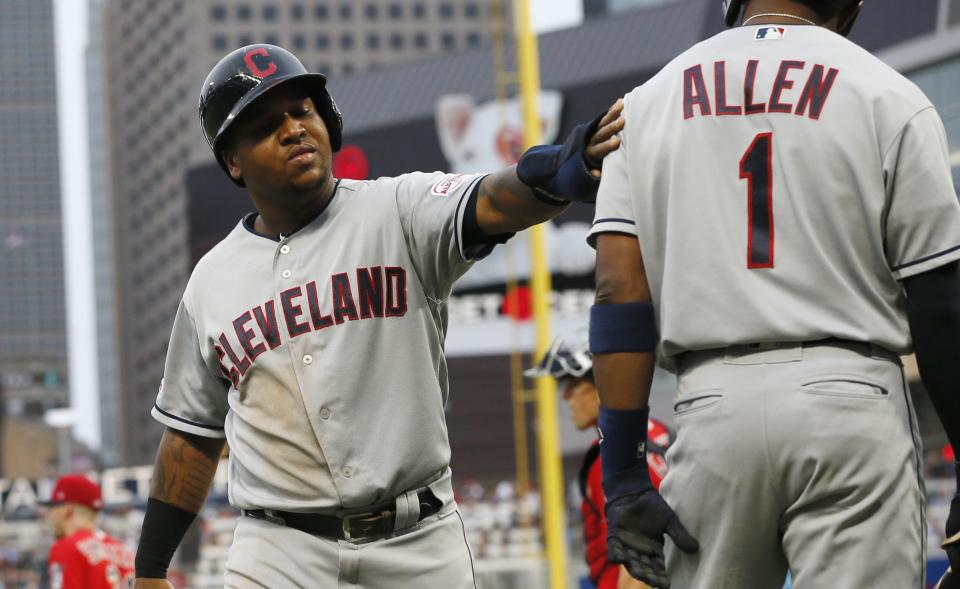 Cleveland Indians' Jose Ramirez, left, scores on a double by Franmil Reyes off Minnesota Twins pitcher Devin Smeltzer during the second inning of a baseball game Friday, Aug. 9, 2019, in Minneapolis. (AP Photo/Jim Mone)