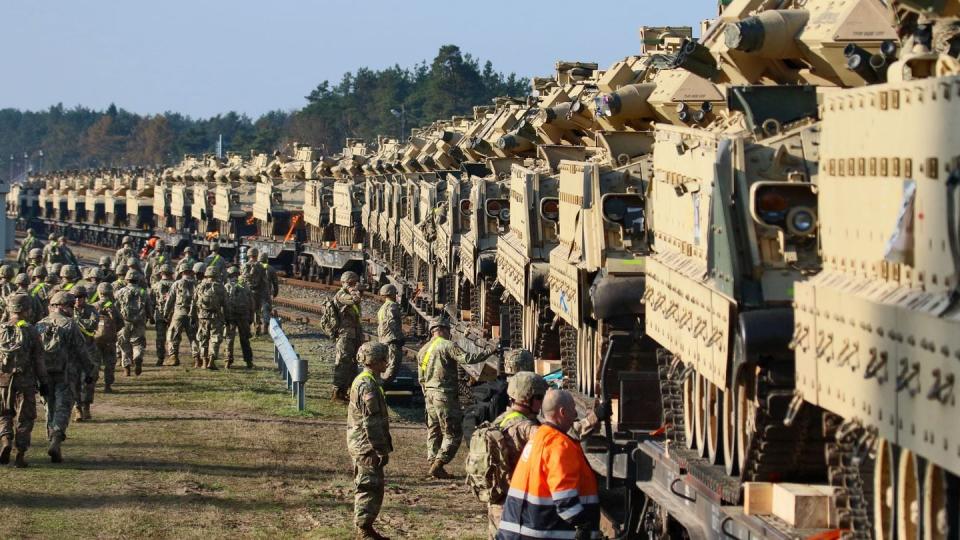 U.S. Army soldiers unload heavy combat equipment, including Abrams tanks and Bradley fighting vehicles, near the Pabrade military base in Lithuania in October 2019. (Petras Malukas/AFP via Getty Images)