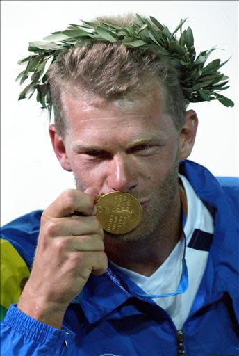 Brazilian gold medallist Robert Scheidt kisses his medal during the awards ceremony for the open single-handed laser class sailing event at the 2004 Olympic Games in the Agios Kosmas Olympic Center in Athens, 22 August 2004. AFP PHOTO/MENAHEM KAHANA