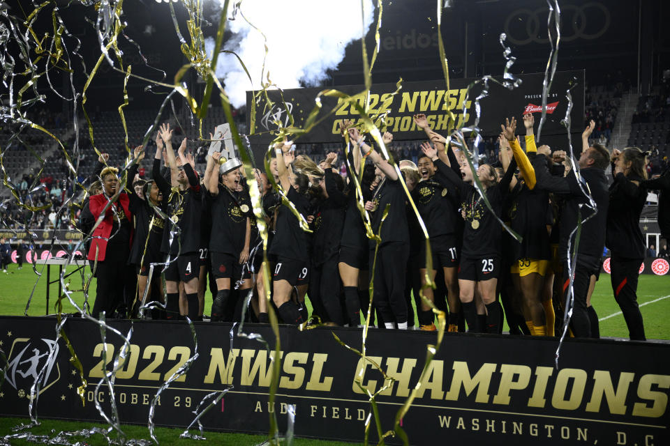 Portland Thorns FC celebrate with the trophy after they won the NWSL championship soccer match against the Kansas City Current, Saturday, Oct. 29, 2022, in Washington. Portland won 2-0. (AP Photo/Nick Wass)