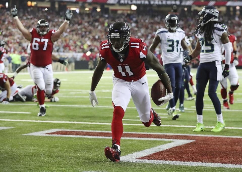 Atlanta Falcons wide receiver Julio Jones scores a touchdown against the Seattle Seahawks during the first quarter of an NFL football NFC divisional playoff game Saturday, Jan. 14, 2017, in Atlanta. (Curtis Compton/Atlanta Journal-Constitution via AP)