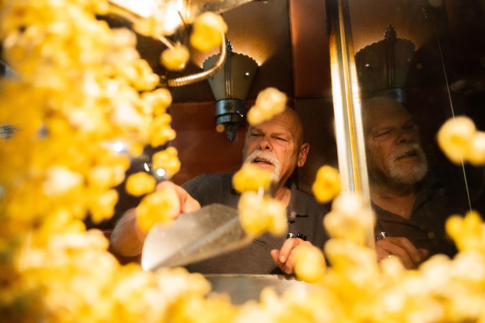 Alan Bradshaw tosses popcorn at the Ritz Theater in Tooele on June 9, 2023. | Ryan Sun, Deseret News