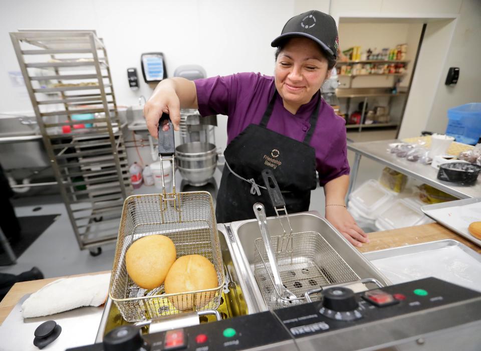 Eira Terrazas, head pastry chef at the Friendship Bakery, removes Hanukkah doughnuts, or sufganiyot, from the fryer at Friendship Circle Bakery in Fox Point.