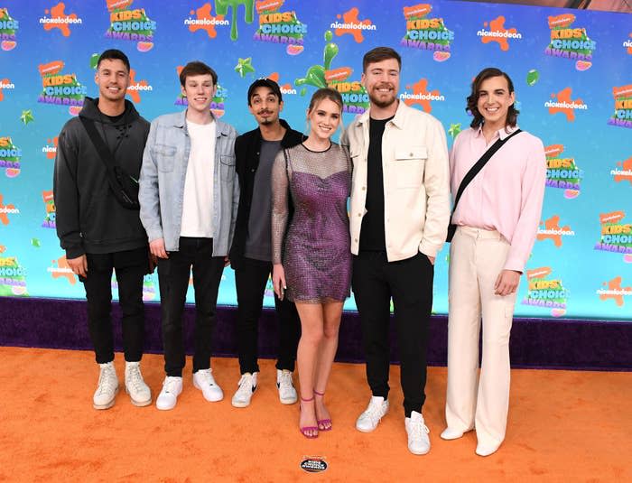 chris with on the red carpet with a group of people