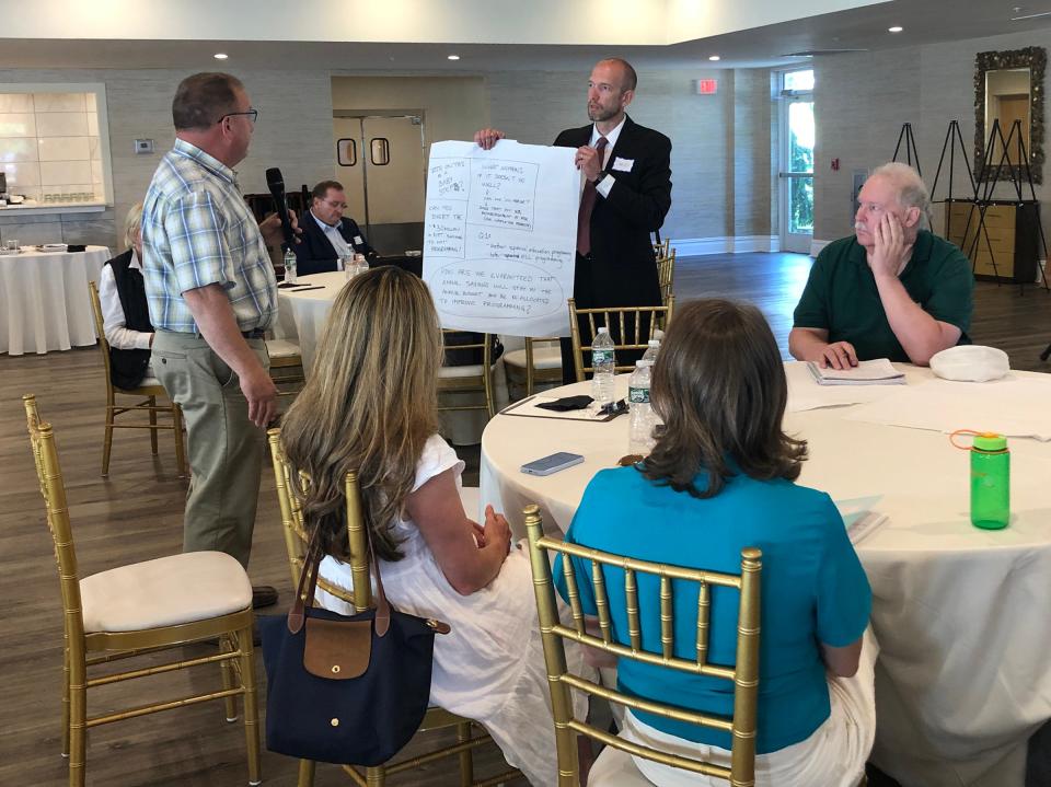 David Sturtz, center, of Woolpert Consulting leads a discussion regarding a proposed school district merger between Newport and Middletown on Monday at the Wyndham Newport Hotel.