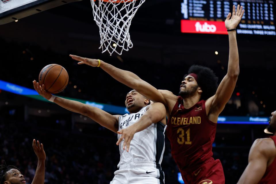 San Antonio Spurs forward Keldon Johnson (3) shoots against Cleveland Cavaliers center Jarrett Allen (31) during the second half of an NBA basketball game, Monday, Feb. 13, 2023, in Cleveland. (AP Photo/Ron Schwane)