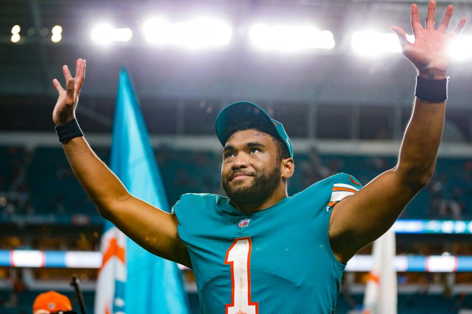 Quarterback Tua Tagovailoa responds to fans after beating the New England Patriots at Hard Rock Stadium.